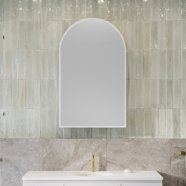 Timberline Church Frame shaving cabinet, arched mirrored white cabinet above a bathroom vanity with tiled wall backdrop
