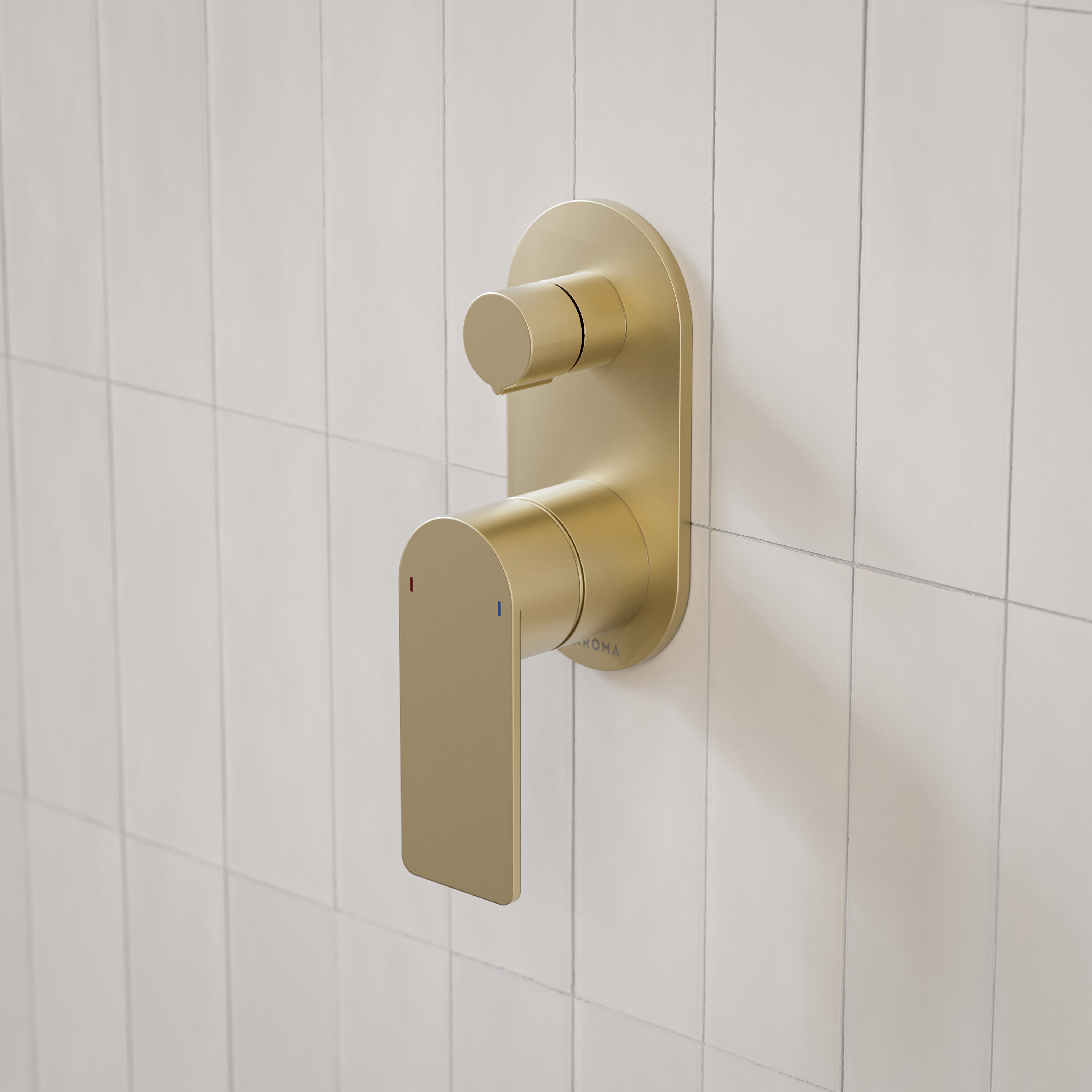 Caroma Urbane II round wall-mounted bath/shower mixer with diverter in brushed brass on white tiled wall