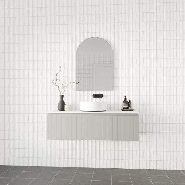 Marquis Valencia wall hung vanity in grey with fluted front, white benchtop and round basin in a tiled bathroom setting