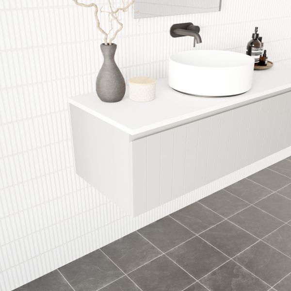 Marquis Valencia wall hung vanity in white, with offset bowl and wall-mounted design in a tiled bathroom.
