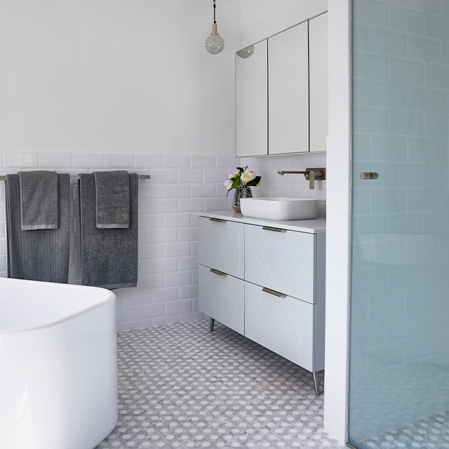Caroma Luna gloss white above counter basin on white vanity in a modern bathroom