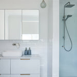 Caroma Luna white gloss above counter basin on a vanity, with wall mirror and shower in a modern bathroom
