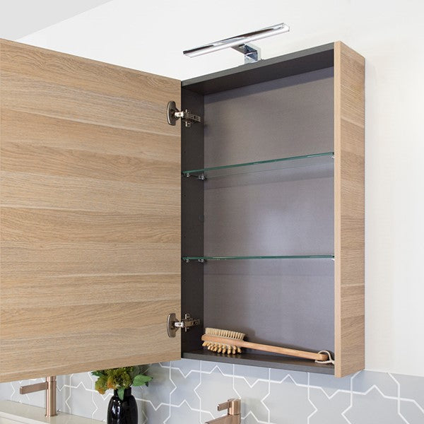 ADP Glacier Pro shaving cabinet open, showing graphite interior, glass shelves and woodgrain finish with mirror door hardware