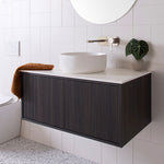 ADP Clifton wall-hung vanity in dark woodgrain with white Caesarstone top and round basin, shown in a bathroom.