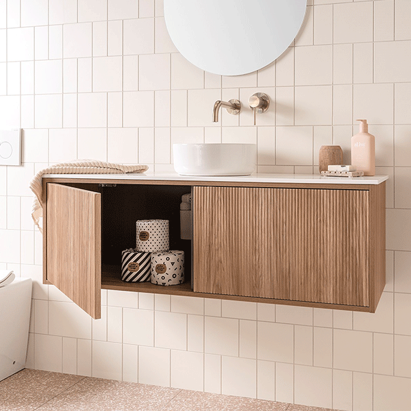 ADP Clifton wall-hung ensuite vanity with woodgrain finish, white top and round basin in a tiled bathroom