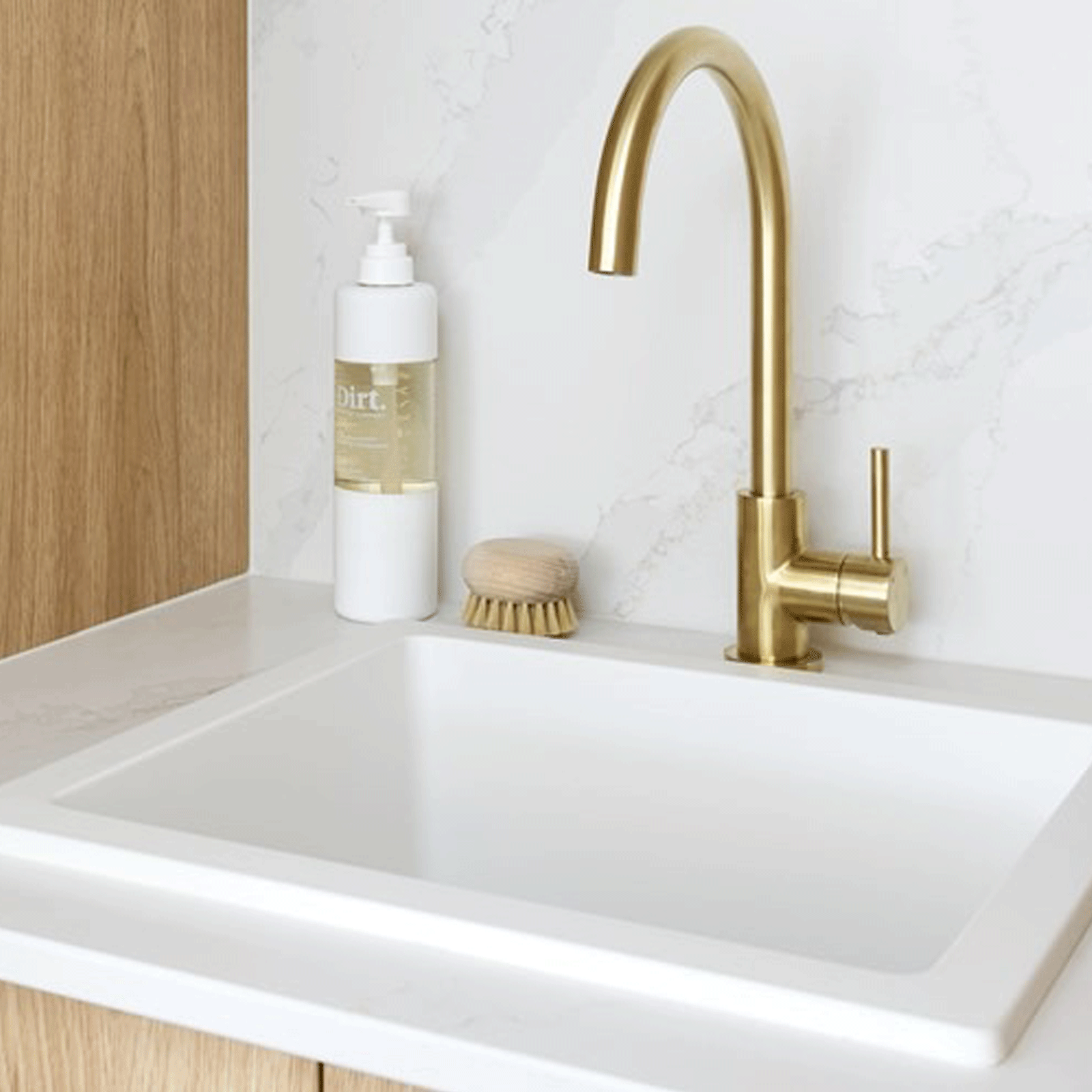 ADP Bellevue small rectangular matte white sink in a bathroom vanity, with brushed gold gooseneck mixer tap