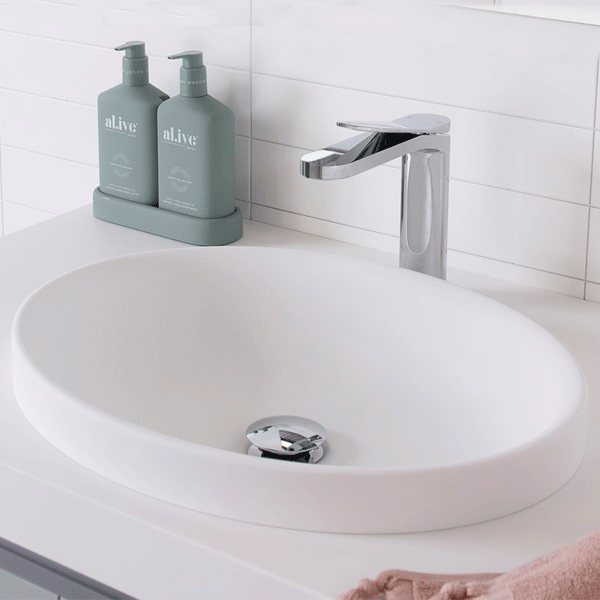 ADP Dignity semi inset basin in matte white, oval ceramic bathroom basin with chrome tap on vanity