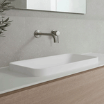 ADP Faith rectangular solid surface basin in white, sitting above a vanity against grey tiled wall, matte finish