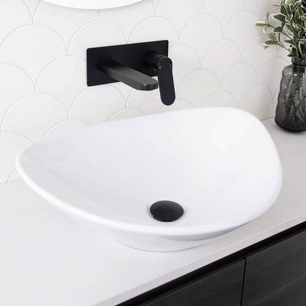 ADP Fiore white above counter basin with soft rounded shape and black waste, shown installed on vanity with wall mixer