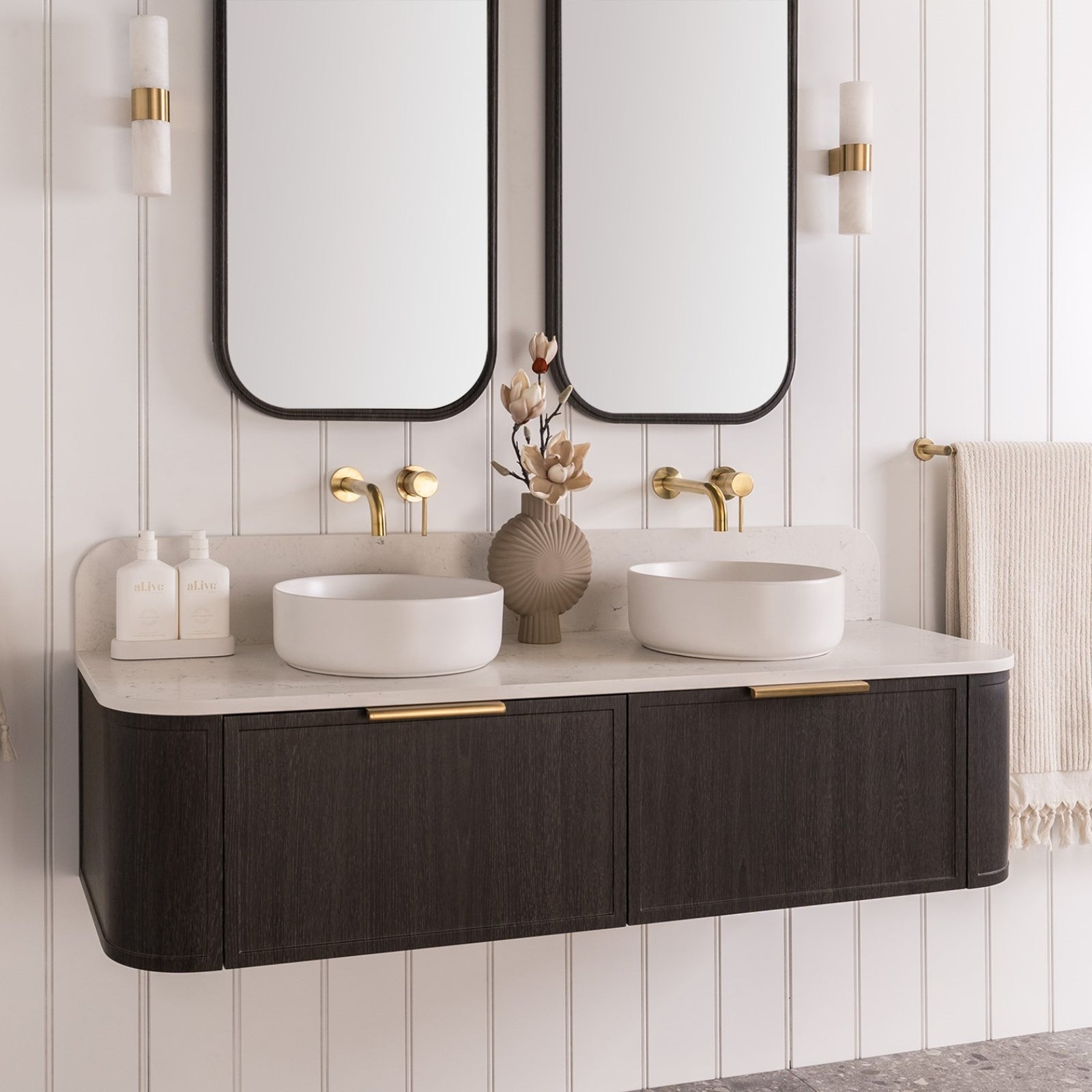 ADP Flo wall hung vanity with Durasein top, dark woodgrain finish, brass handles and double bowl in a bathroom setting