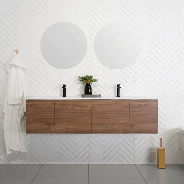 ADP Glacier Pro wall hung slim vanity with ceramic top in walnut finish, shown in a bathroom setting with round mirrors
