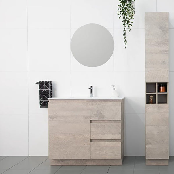 ADP Glacier Lite freestanding vanity with ceramic top in concrete woodgrain finish, shown in bathroom setting with tallboy cabinet