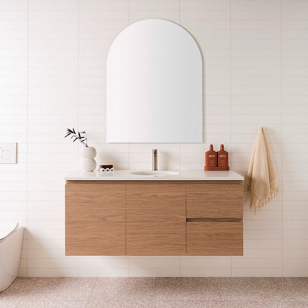 ADP Glacier Lite wall hung vanity with woodgrain finish and white top, centre basin, doors and drawers in bathroom setting