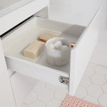 White ADP Glacier Lite vanity drawer open with bathroom accessories on a tiled floor