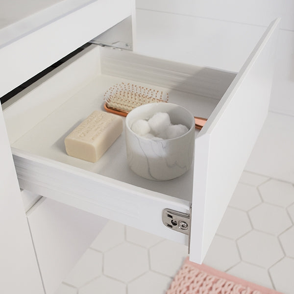 White ADP Glacier Lite vanity drawer open with bathroom accessories on a tiled floor