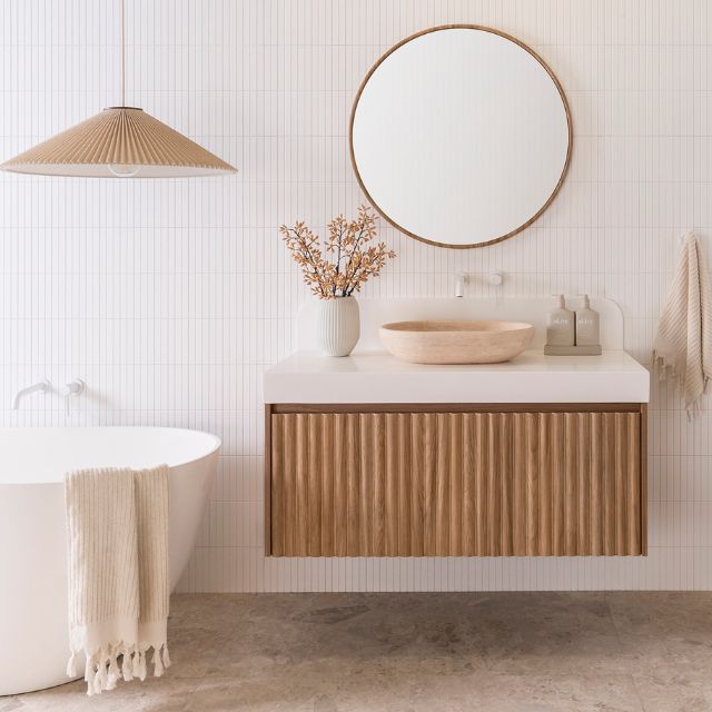 ADP Harper wall hung vanity in Prime Oak with white Durasein benchtop, centre bowl basin and fluted drawer front in bathroom setting