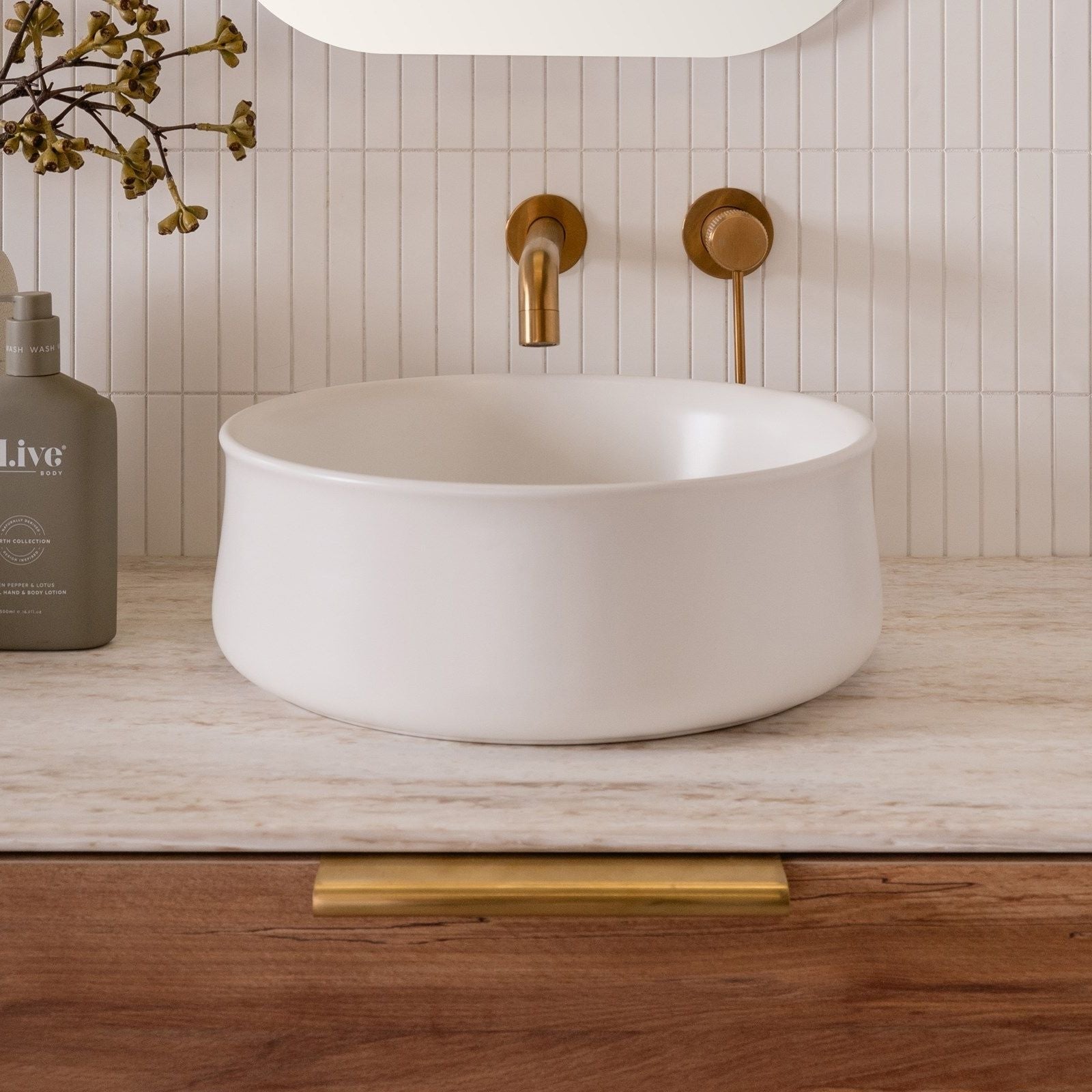 ADP Jennifer round matte white above-counter ceramic basin on a timber vanity with gold tapware