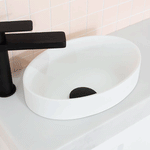 ADP Joy gloss white semi inset round bathroom basin on a white benchtop with black tapware, close-up view
