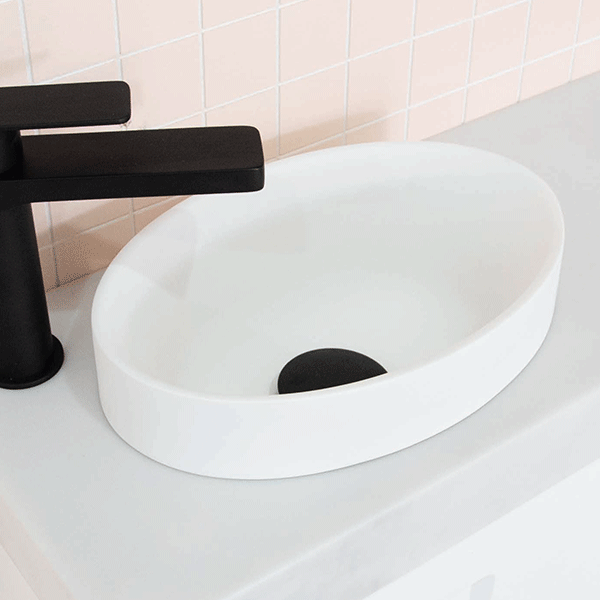 ADP Joy gloss white semi inset round bathroom basin on a white benchtop with black tapware, close-up view