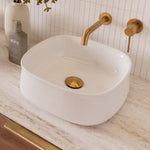 ADP Love gloss white square above-counter ceramic basin on stone vanity with gold tapware