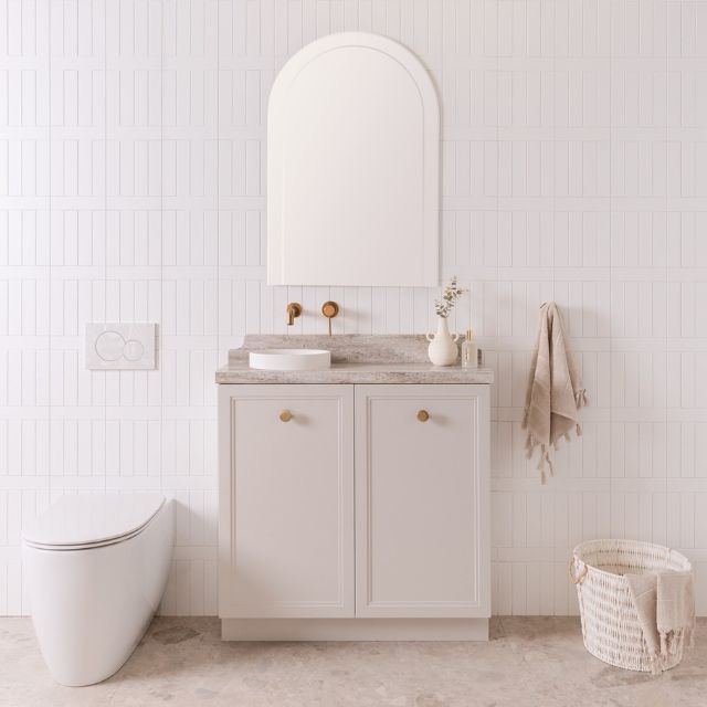 ADP Mabel Mini freestanding vanity in feather grey with Durasein benchtop, white basin and brushed brass handles in bathroom setting