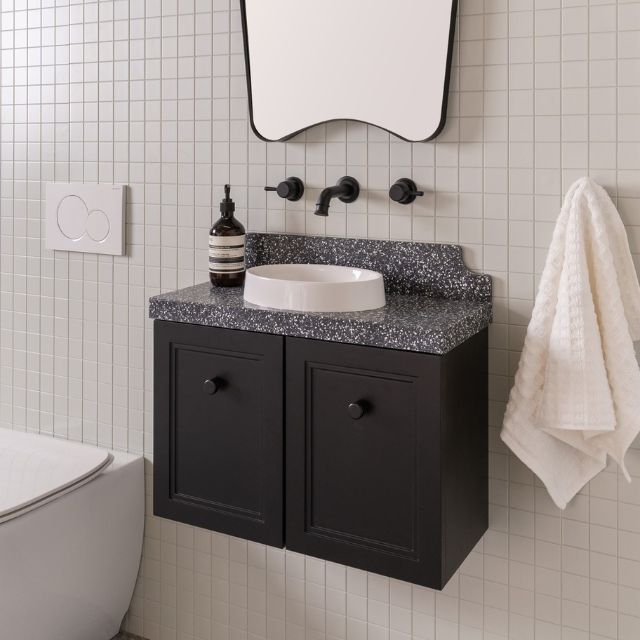 ADP Mabel Mini wall hung vanity in matte black with speckled Durasein benchtop and round white basin in bathroom setting