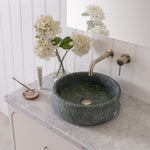 ADP Madden wall hung vanity with Caesarstone benchtop, grey finish, green stone basin and brushed brass tapware.