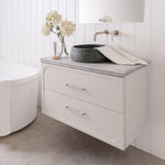 ADP Madden wall hung vanity in white with grey Caesarstone benchtop, twin drawers and brushed metal handles in bathroom setting