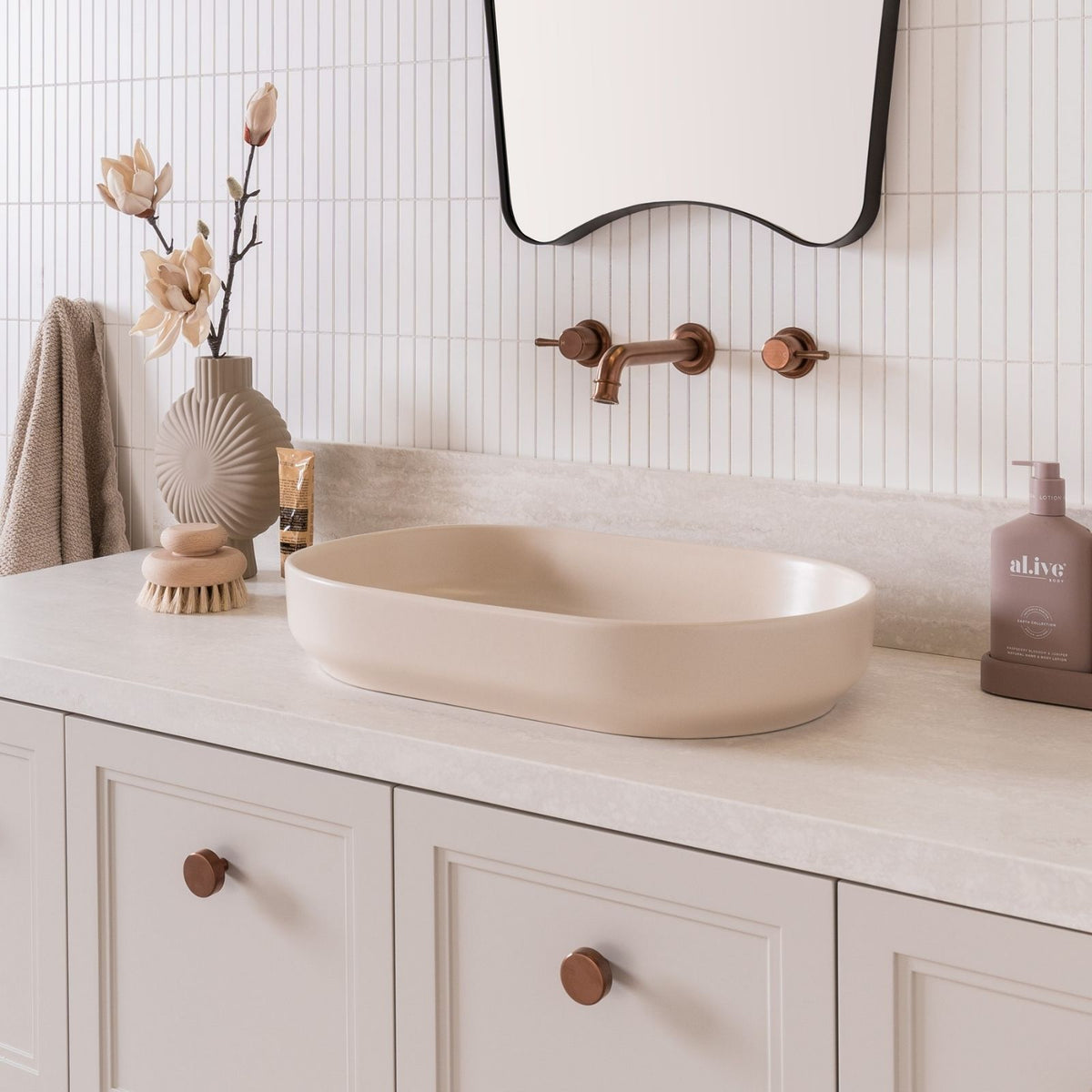 ADP Marilyn matte ivory above counter oval bathroom basin on a vanity in a styled bathroom setting
