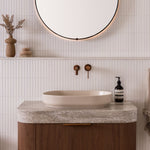 ADP Marilyn matte ivory oval above counter basin on a vanity, shown in a bathroom setting with wall-mounted tapware