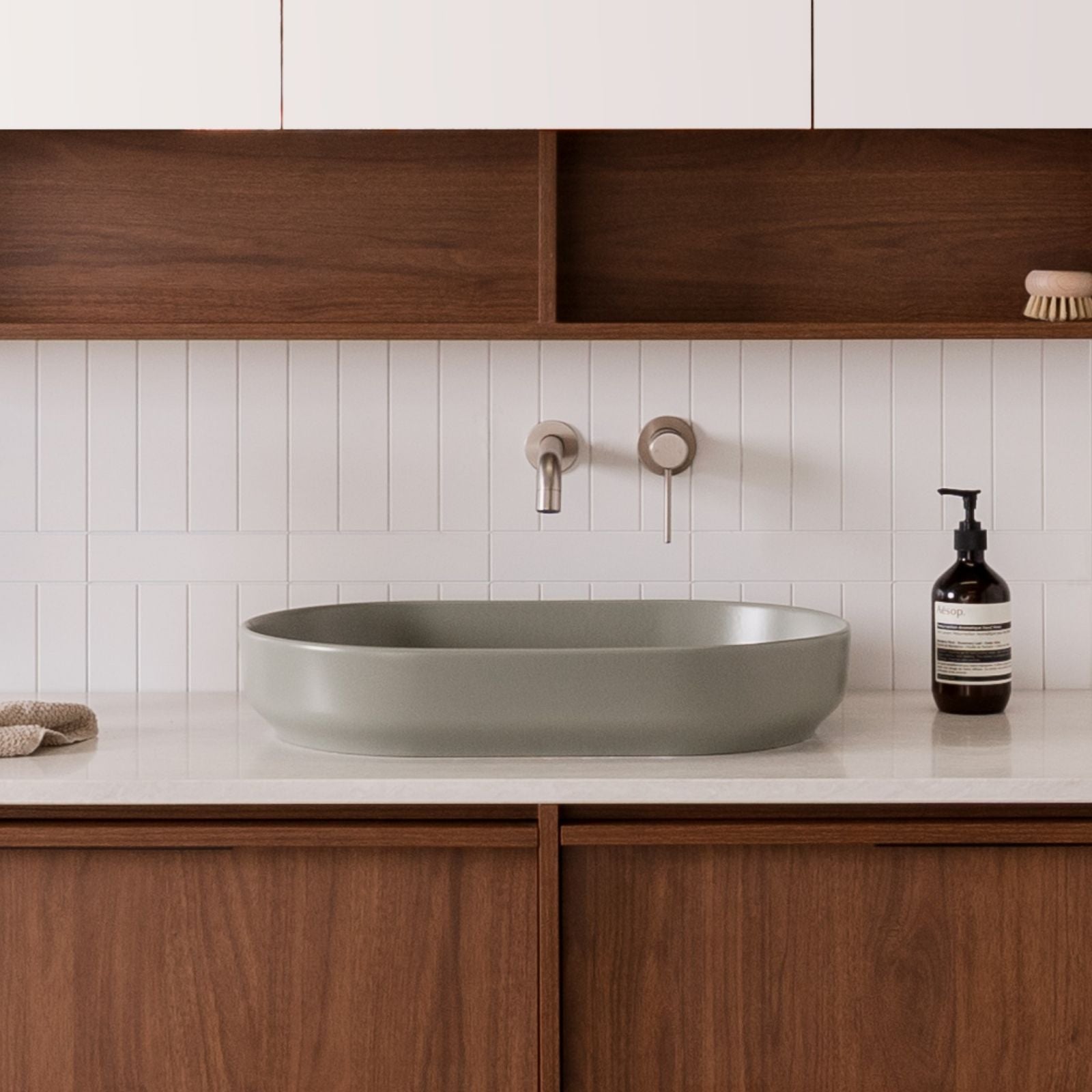 ADP Marilyn matte olive oval above counter basin on a bathroom vanity, with wall-mounted tapware and timber cabinetry