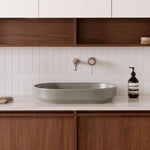 ADP Marilyn matte olive oval above counter basin on a bathroom vanity, with wall-mounted tapware and timber cabinetry