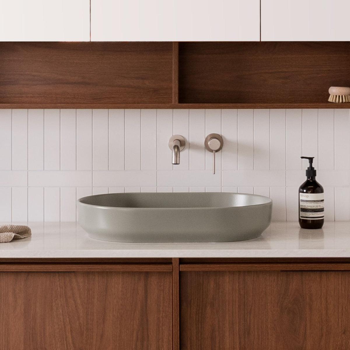ADP Marilyn matte olive oval above counter basin on a bathroom vanity, with wall-mounted tapware and timber cabinetry