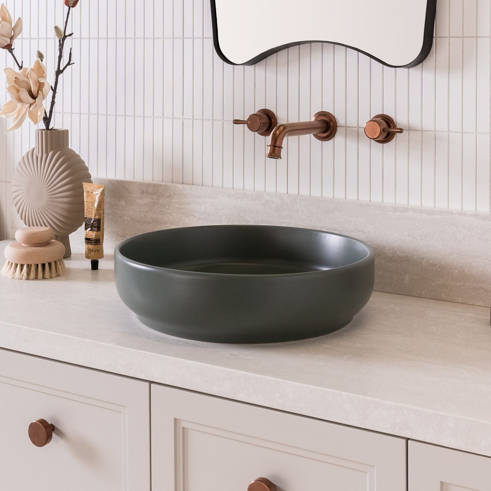 ADP Monroe matte forest round above counter basin on a vanity, with copper wall tapware in a styled bathroom scene
