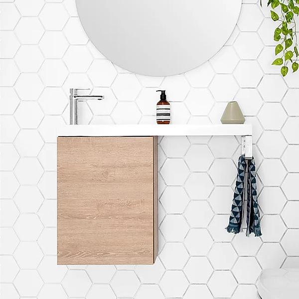 ADP Petite Rail wall hung vanity with white top and woodgrain cabinet, integrated towel rail, in a tiled bathroom