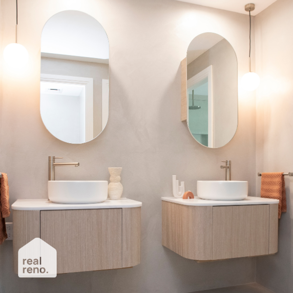 ADP Pill oval shaving cabinet mirror above a bathroom vanity, shown in a modern double basin ensuite setting