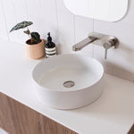 ADP Robbie round white above counter basin on vanity with wall-mounted mixer tap, lifestyle view
