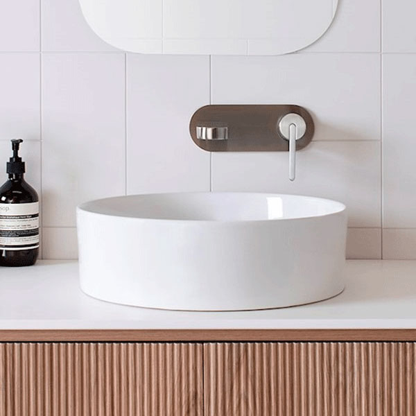 ADP Robbie round gloss white above counter basin on vanity bench with wall-mounted tapware
