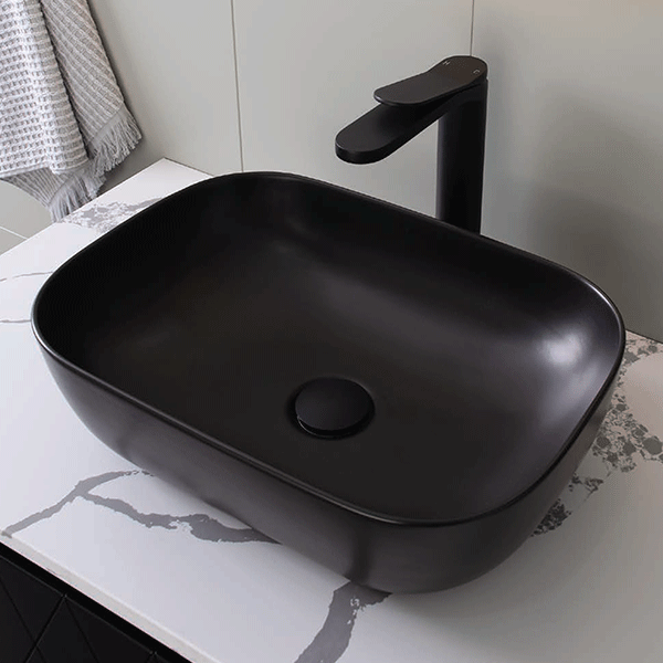 ADP Stadium matte black rectangular above counter bathroom basin on white benchtop with black mixer tap
