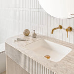 ADP Surry Imperial wall hung vanity with fluted edge top, matte white basin and brushed brass tap in a white tiled bathroom