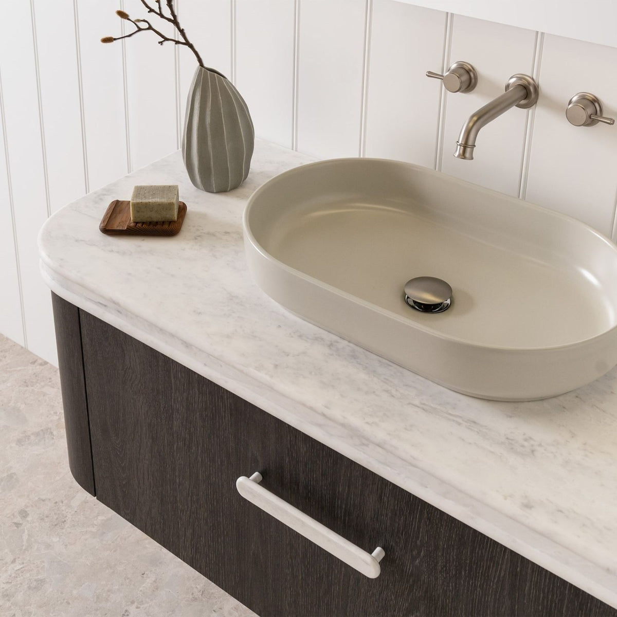 Round marble-look vanity benchtop with integrated basin, shown on a bathroom vanity with brushed nickel tapware and white panelling