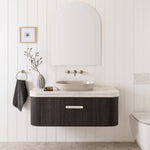 White rounded vanity benchtop with bullnose edge above dark wood ADP vanity in a bathroom setting
