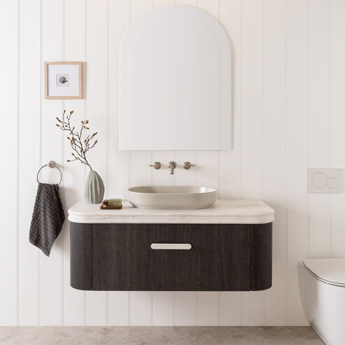 White rounded vanity benchtop with bullnose edge above dark wood ADP vanity in a bathroom setting