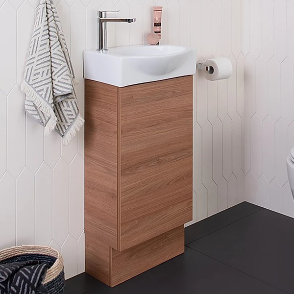 ADP Tiny semi-recessed floor standing vanity with woodgrain finish and gloss white basin, in a small bathroom setting