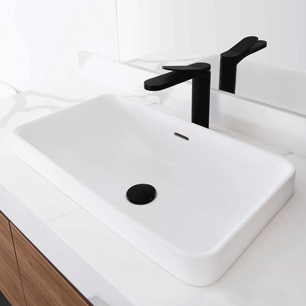 ADP Zeya rectangular solid surface inset basin in gloss white, with overflow, on a white vanity with black tapware.