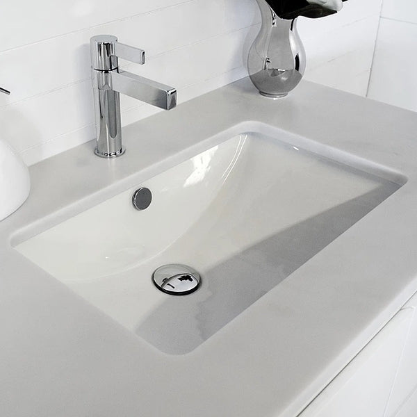 ADP Scoop white ceramic rectangular under counter basin installed in a vanity top, with chrome mixer tap