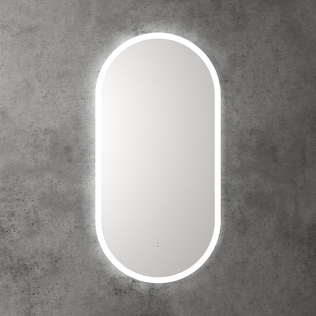 Aulic Beau Monde frameless oblong LED mirror with backlit glow, wall mounted on a concrete-look wall
