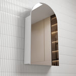 Aulic Canterbury arch shaving cabinet in white, wall-mounted with mirrored door and arched top in tiled bathroom setting