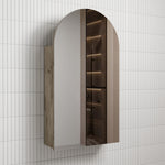 Aulic Canterbury Arch Shaving Cabinet with arched mirrored door, Mia finish and woodgrain side panel mounted on tiled wall