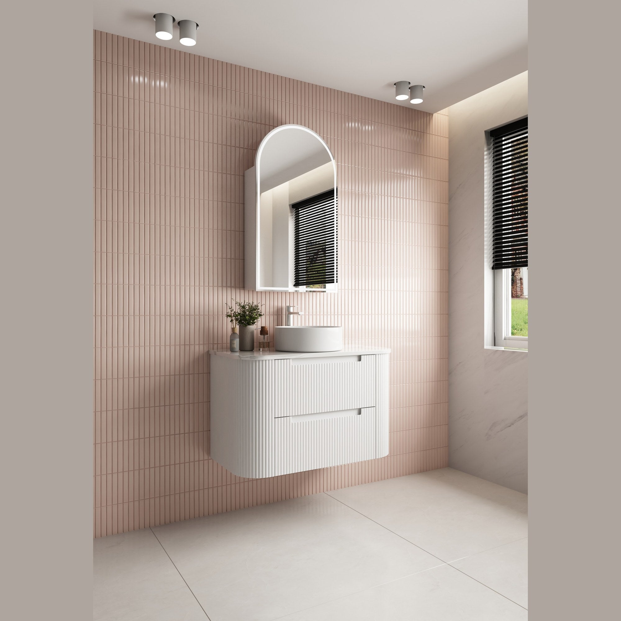 Aulic Curva white wall hung vanity with curved front, stone top and round basin in a pink tiled bathroom vignette